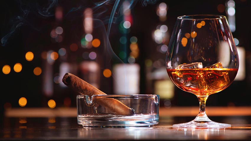 wealthy art collectors with whisky and cigar
